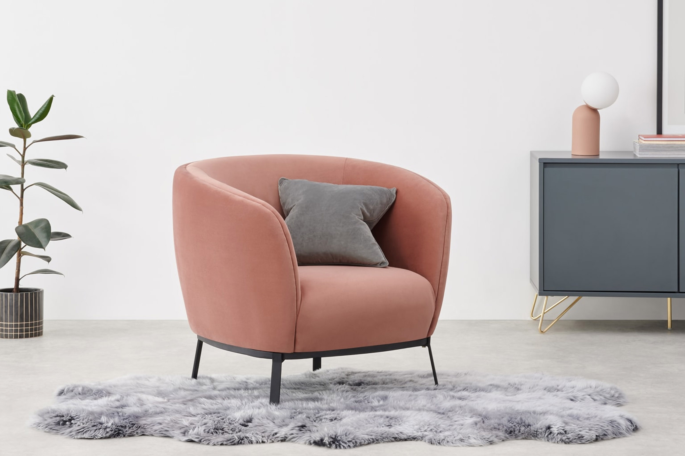 Soft pink Belle Accent Chair with gray contrast cushions and black steel base